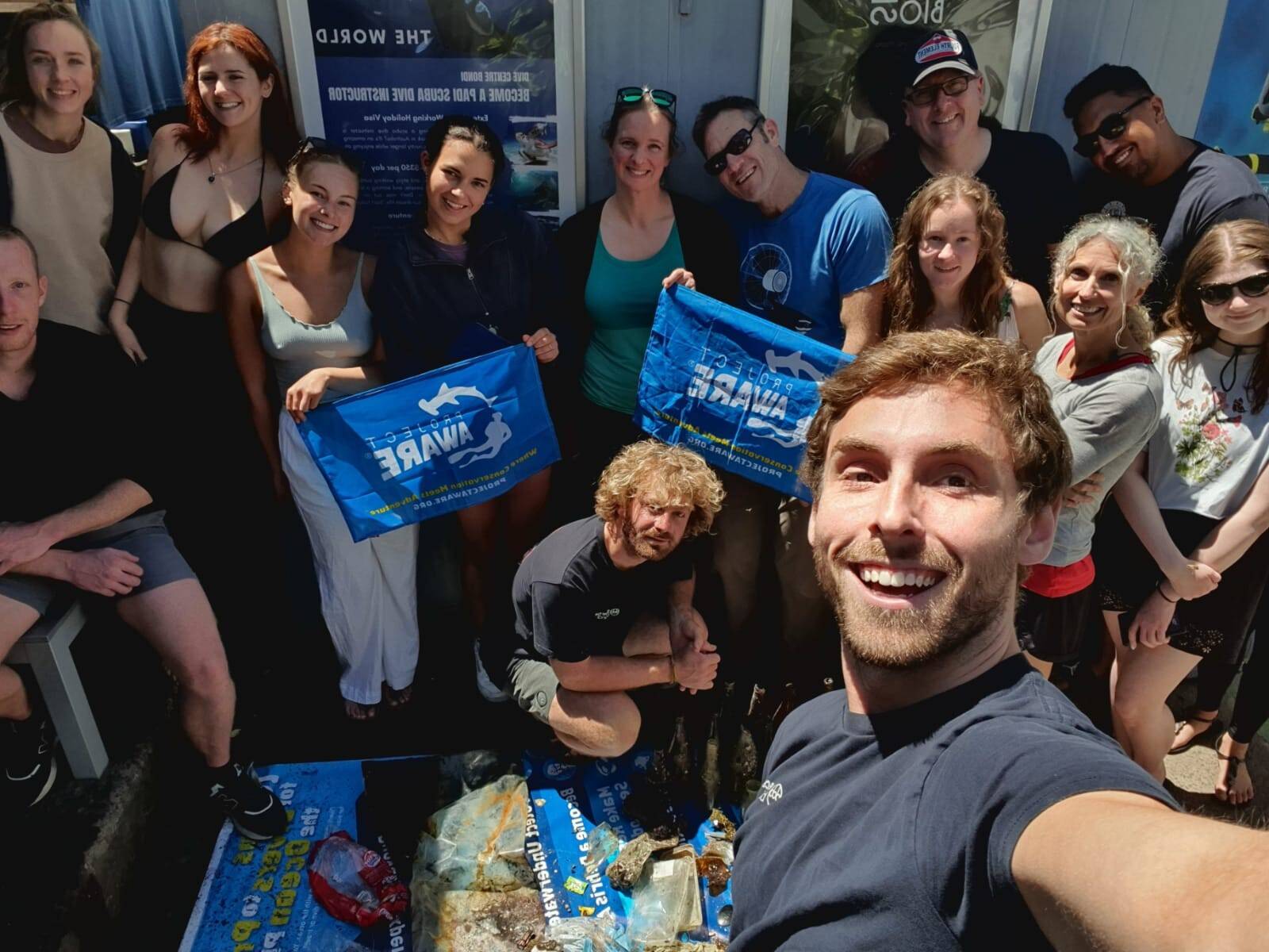 Group of happy scuba divers in Sydney after an ocean clean up